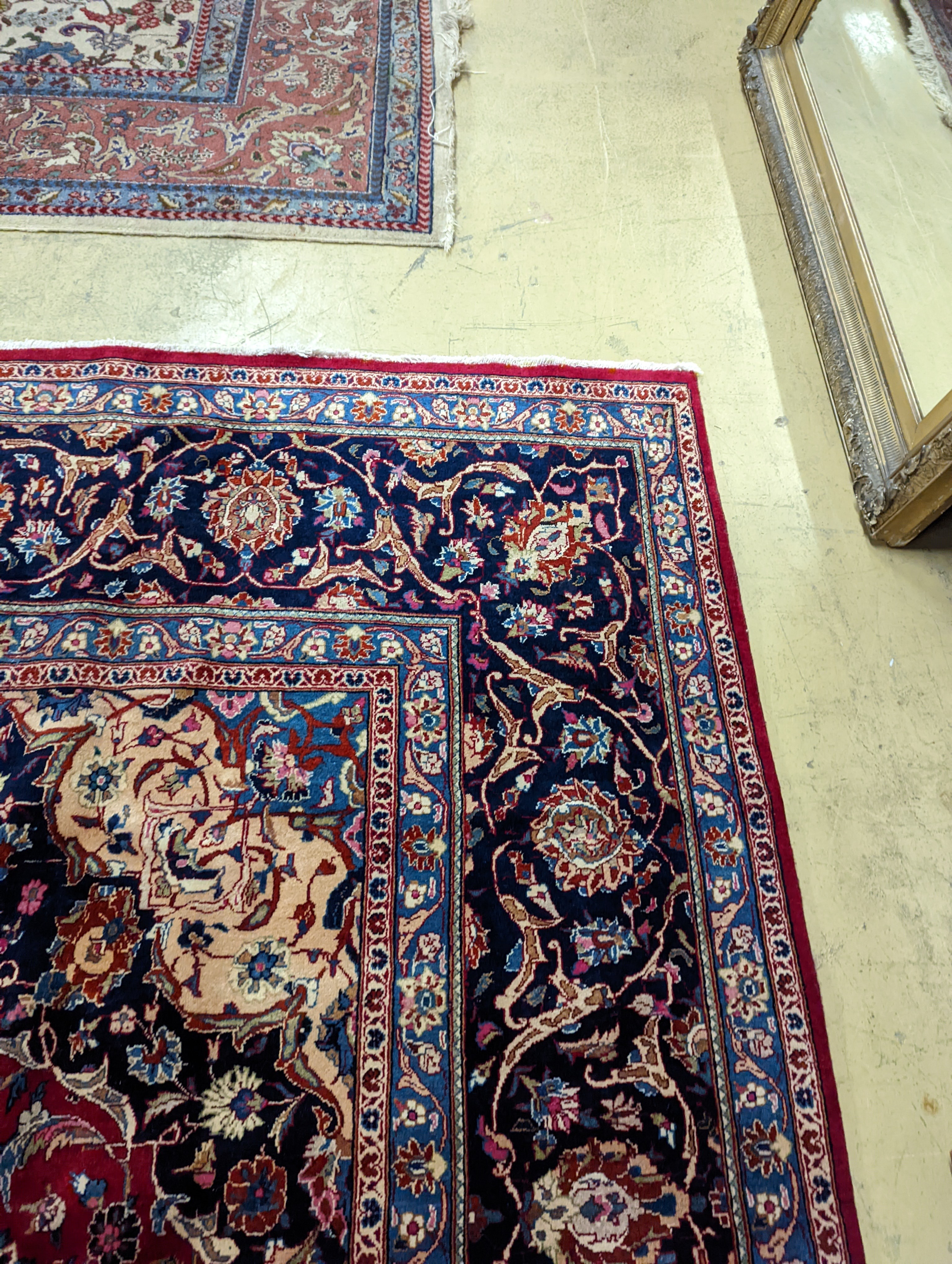 A Kashan burgundy ground carpet, 380 x 300cm